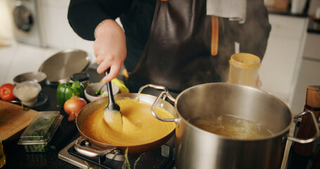 Hands, cooking and chef with pot, culinary and preparation for dinner in kitchen, cuisine or restaurant. Catering, employee and person with food for supper, hospitality or skills for gourmet in diner