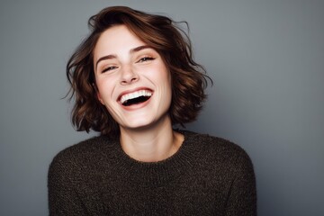 Laughing Woman with Brown Hair on Gray Background