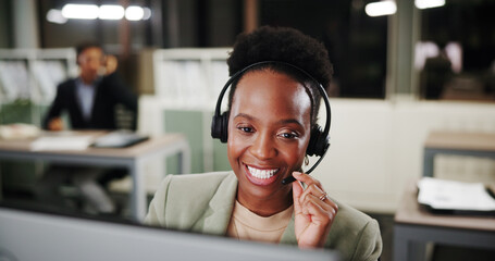 Call center, headset and happy woman on computer for telemarketing, crm or coworking at night. Agent, contact us and listening for customer service with lead generation, outbound telecom or overtime