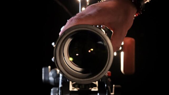 Capturing Light A Hand Adjusts Professional Camera Lens in Studio