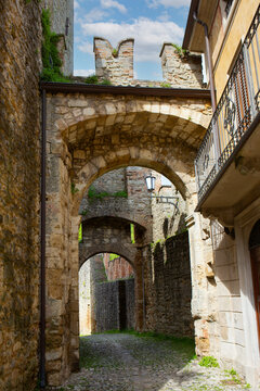 Historic stone architecture with multiple arches charming alleyway travel scene.