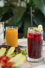 Close up view of a glass of fresh peach juice served on a restaurant table.