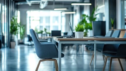 Modern empty office workspace with desks, chairs, and plants.