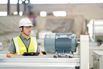 asian male engineer woking on digital tablet in factory with  Industrial fan impeller