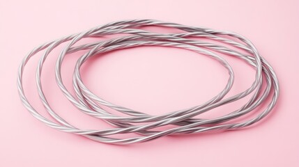 Twisted silver rings on pink background