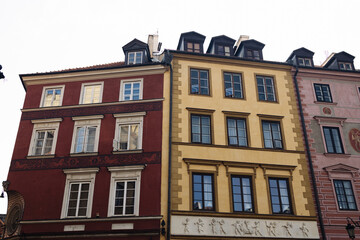 Traditional multicolored buildings in the historic Old Town of Warsaw, Poland. Classic European architecture with bright facades and dormer windows. Great for travel, heritage, and urban visuals.