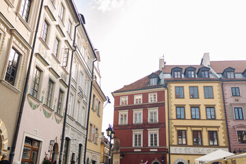 Traditional multicolored buildings in the historic Old Town of Warsaw, Poland. Classic European architecture with bright facades and dormer windows. Great for travel, heritage, and urban visuals.