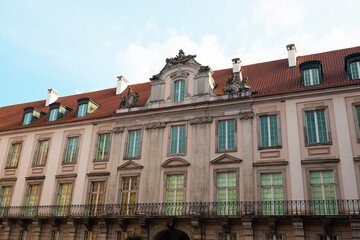 Elegant baroque-style building with a red-tiled roof and decorative stone facade in Warsaw’s historic center. A cultural heritage site perfect for travel, European cityscapes, and architectural
