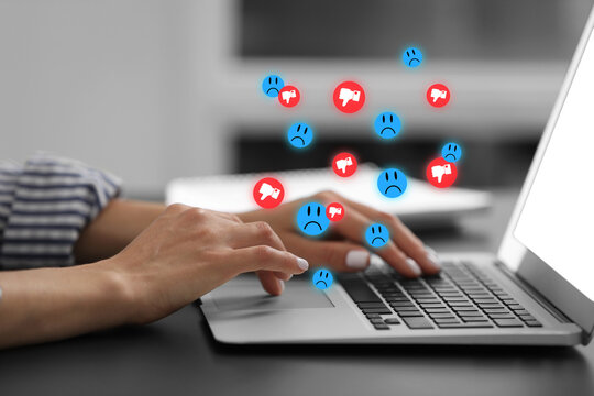 Woman using laptop at table, closeup. Social media notifications flying out of computer - Powered by Adobe
