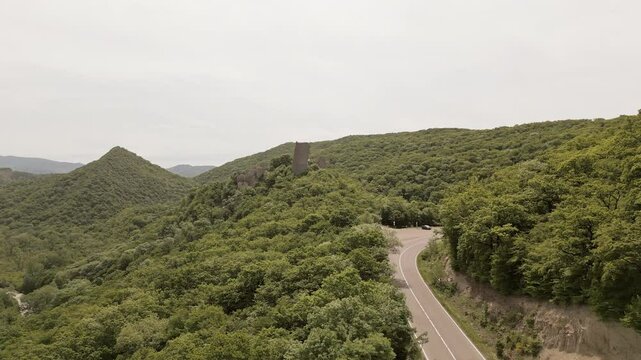 Aerial view Ujarma Fortress and countryside road. Ancient Hilltop Royal Citadel and Strategic Stronghold of the Iberian Kings in Kakheti, Georgia. Sightseeing destination in Kakheti wine region