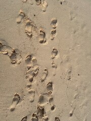 Footsteps mark on the sand at the beach