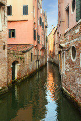 A view of the Rio di San Giovanni Grisostomo, a narrow canal in the sestiere of Cannaregio, Venice, Veneto, Italy