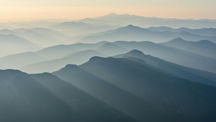 Fototapeta premium Blue layered mountain range with a misty atmosphere