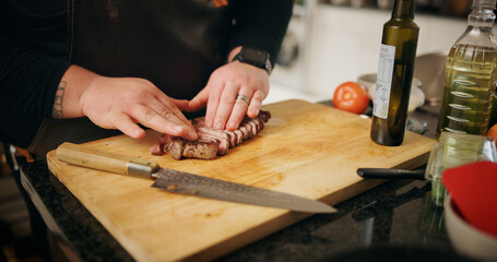 Kitchen, hands and man with steak, cutting or culinary skills with food, wood board or healthy ingredients. Person, closeup or chef with meal prep meat or beef cuisine with knife, nutrition or home
