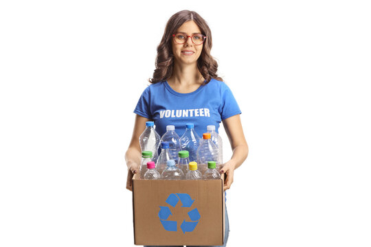 Young female volunteer carrying a cardboard box with plastic bottles