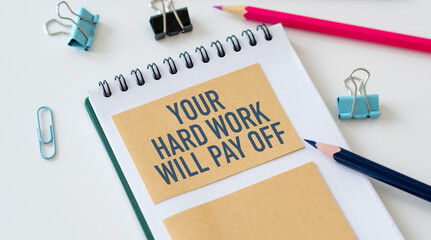 Your Hard Work Will Pay Off with inspiring text on notepad and white desk. You need to work harder than others, learn and improve.