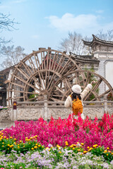 Young female tourist enjoys traveling at Lijiang Ancient Town, The famous tourist destination at Yunnan Province, China