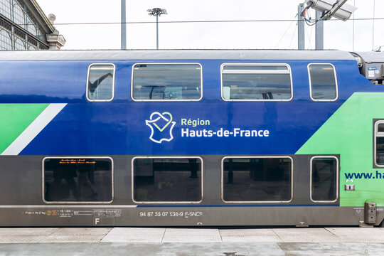 Paris, France - 23 February 2025:  Double-decker TER Hauts-de-France regional train at platform, modern blue and green SNCF carriage with logo, public transport travel