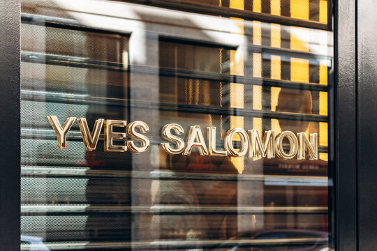 Paris, France - 23 February 2025: Yves Salomon boutique sign on 245 rue Saint-Honor&eacute;, gold letters on glass, luxury fashion store in Paris