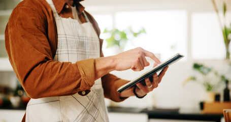 Hands, tablet and man in kitchen, cooking and connection with online recipe, app and instructions. Closeup, person and chef with tech, home and internet with ingredients, network or website for food