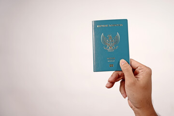 Indonesian passport held in hand isolated on white background