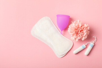 Menstrual cup on a bright background. Sanitary napkins, tampons and menstrual cup.Concept of critical days, menstruation.feminine hygiene product. Women health concept.Premenstrual syndrome.Copy space