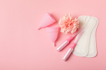 Menstrual cup on a bright background. Sanitary napkins, tampons and menstrual cup.Concept of critical days, menstruation.feminine hygiene product. Women health concept.Premenstrual syndrome.Copy space