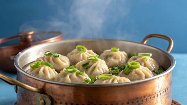 Pan-fried chicken momo with green vegetables create a healthy and flavorful dinner dish alongside cooked HD video download.
