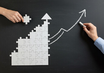 White person-icon puzzle almost complete on wood, with a blue piece ready to fit in, symbolizing integration.
