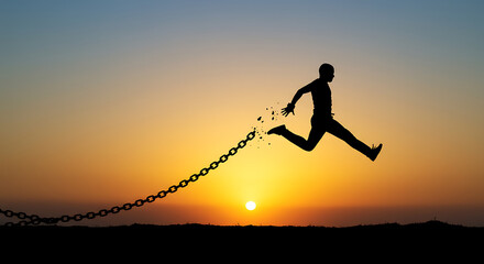 Silhouette of a Man Breaking Free from Chains at Sunset Freedom Concept
