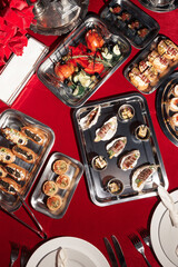 Assorted elegant canapés and hors d’oeuvres on metal trays, featuring seafood, vegetables, and savory pastries — perfect for upscale events.