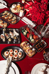 Assorted elegant canapés and hors d’oeuvres on metal trays, featuring seafood, vegetables, and savory pastries — perfect for upscale events.