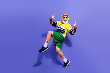 Funny man in retro athletic attire enthusiastically posing against vibrant background, evoking old...