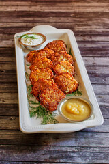 Potato pancakes with sour cream and apple sauce