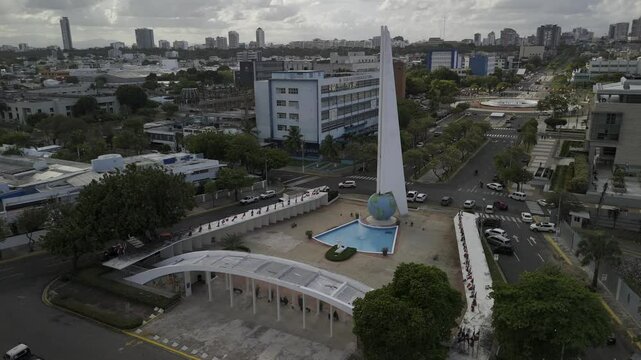 Drone slowly flies over the Monument to the Heroes of Constance, Maimon and Estero Hondo on cloudy afternoon in Santo Domingo, Dominican Republic