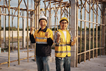 A team of engineers wearing hard hats inspect construction and inspect the site to ensure quality...
