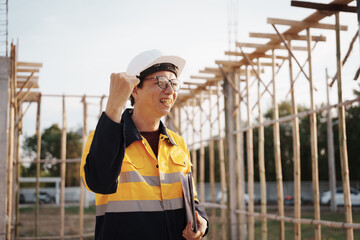 A team of engineers wearing hard hats inspect construction and inspect the site to ensure quality...