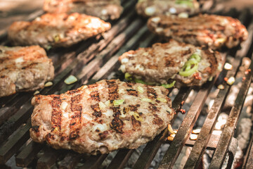 Grilling beef patties at a backyard barbecue gathering