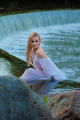 Beautiful Girl with long hair swims and dances in water