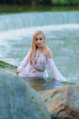 Beautiful Girl with long hair swims and dances in water