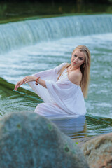 Beautiful Girl with long hair swims and dances in water