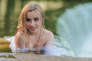 Beautiful Girl with long hair swims and dances in water