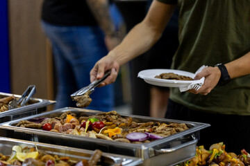 Buffet dining experience featuring a variety of dishes and people enjoying a meal