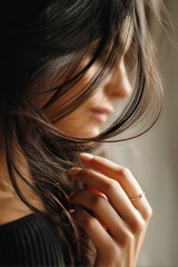 Naklejka premium Portrait of a young woman with flowing hair enjoying a moment of contemplation in soft natural light by a window