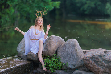Beautiful girl with long hair and horns in a white dress