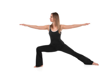 Warrior pose practice in a studio by a dedicated yoga enthusiast showcasing strength and balance during a morning session