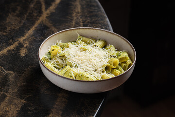 Pesto Rigatoni – Al dente rigatoni pasta tossed in fresh basil pesto and topped with grated Parmesan cheese.