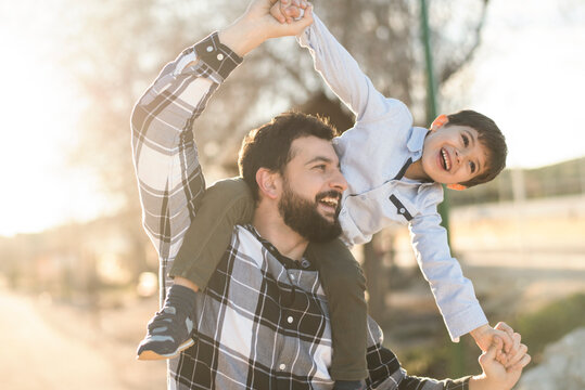 father playing with son in outdoors image