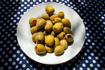 Green Olives in a Bowl on a polka dot table 