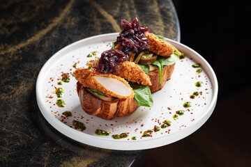 Crispy Chicken Toast with Caramelized Onion – Rustic toast topped with fresh greens, sliced crispy chicken breast, and sweet caramelized red onions, garnished with herb oil.